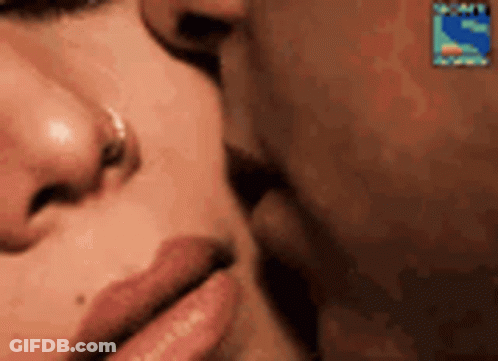 A Close Up Of A Man And A Woman Kissing . GIF