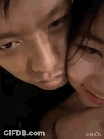 A Close Up Of A Man And A Woman Kissing . GIF
