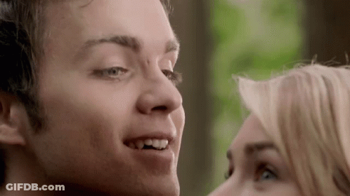 A Close Up Of A Man And A Woman 'S Faces Looking At Each Other GIF