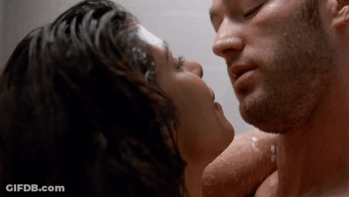 A Close Up Of A Man And Woman Kissing GIF