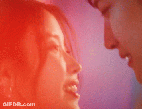 A Close Up Of A Man And Woman Kissing With Their Eyes Closed GIF
