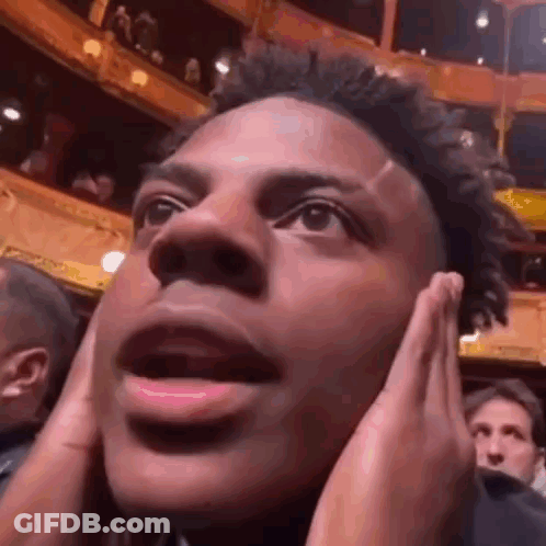 A Close Up Of A Man Covering His Ears With His Hands . GIF