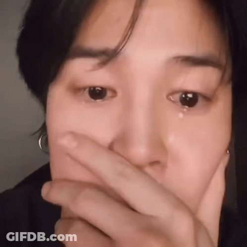 A Close Up Of A Man Covering His Mouth With His Hand . GIF