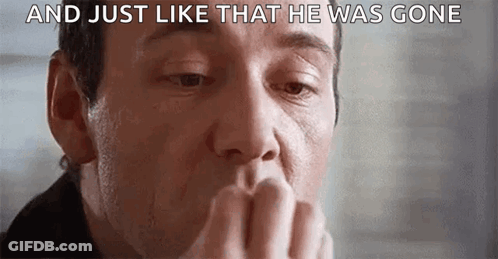 A Close Up Of A Man Covering His Mouth With His Hand And A Caption That Says `` And Just Like That He Was Gone '' . GIF