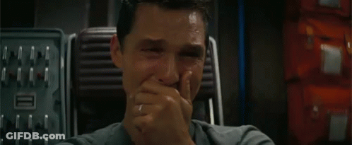 A Close Up Of A Man Covering His Mouth With His Hand . GIF