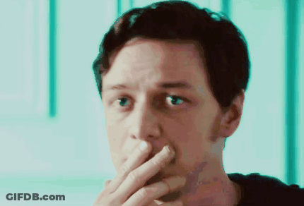 A Close Up Of A Man Covering His Mouth With His Hands GIF