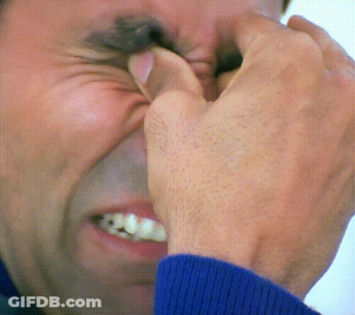 A Close Up Of A Man Covering His Nose With His Hands GIF
