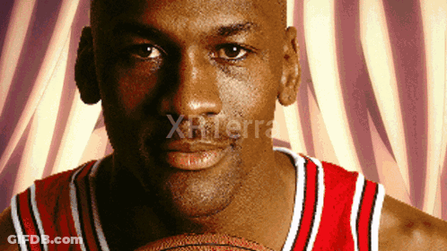 A Close Up Of A Man Holding A Basketball With The Word Xterra On The Bottom Right GIF
