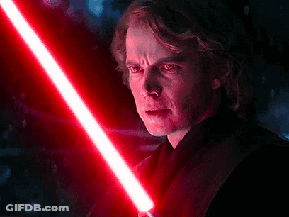 A Close Up Of A Man Holding A Red Lightsaber In His Hand . GIF