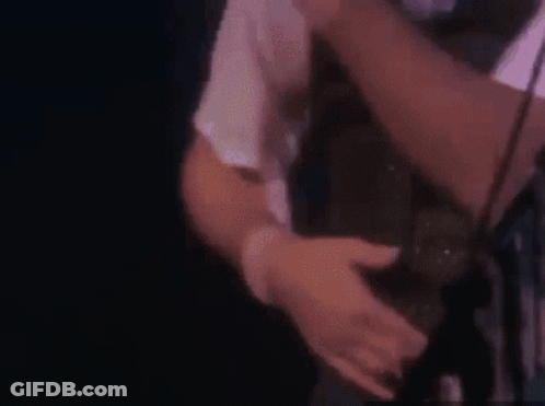 A Close Up Of A Man Holding A Woman 'S Leg In A Chair . GIF