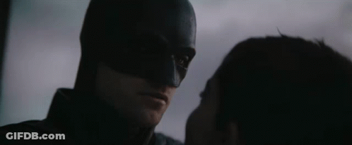 A Close Up Of A Man In A Bat Suit With The Words " The Bat And The Cat " Below Him GIF