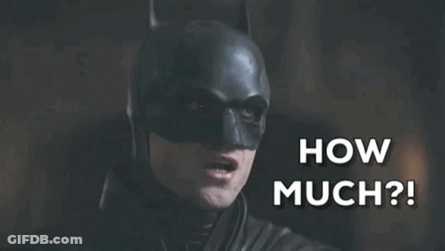 A Close Up Of A Man In A Batman Costume Saying How Much GIF