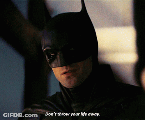 A Close Up Of A Man In A Batman Costume With The Words " Don 'T Throw Your Life Away " GIF