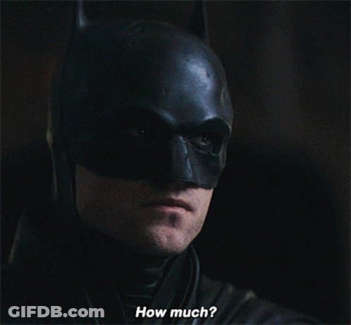 A Close Up Of A Man In A Batman Costume With The Words How Much Below Him GIF