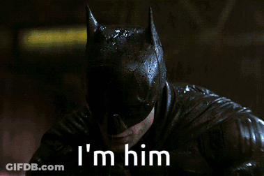A Close Up Of A Man In A Batman Costume With The Words I 'M Him Below Him GIF