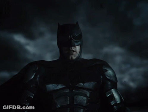 A Close Up Of A Man In A Batman Suit GIF