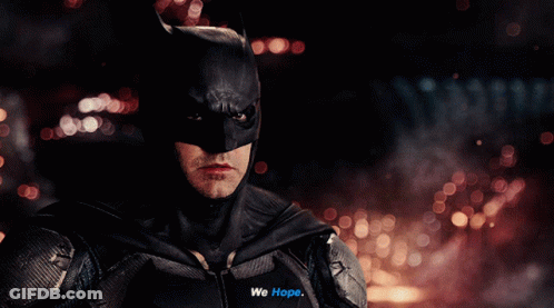 A Close Up Of A Man In A Batman Suit Saying We Hope GIF
