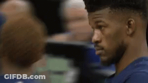A Close Up Of A Man In A Blue Shirt Looking At Another Man . GIF