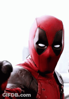A Close Up Of A Man In A Deadpool Costume Pointing At The Camera . GIF