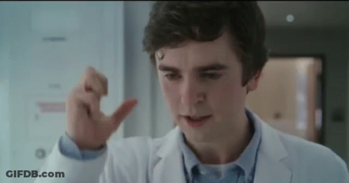 A Close Up Of A Man In A Lab Coat Making A Thumbs Up Sign . GIF