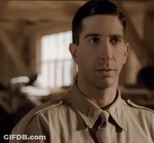 A Close Up Of A Man In A Military Uniform With A Cross On His Collar GIF
