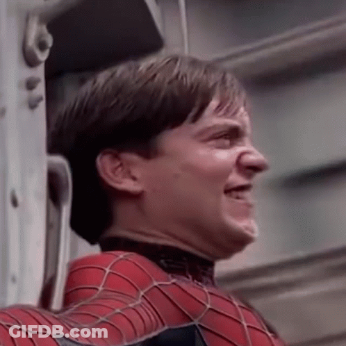 A Close Up Of A Man In A Spiderman Suit Making A Face . GIF