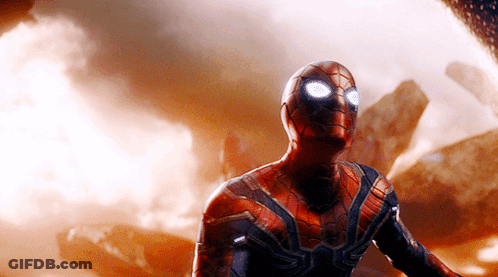 A Close Up Of A Man In A Spiderman Suit With Glowing Eyes GIF