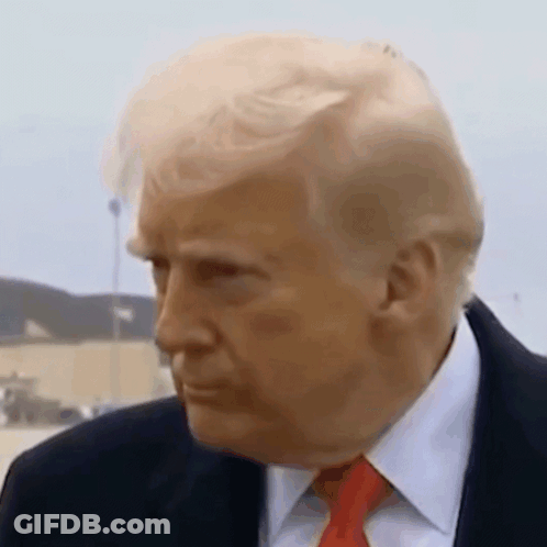 A Close Up Of A Man In A Suit And Tie . GIF