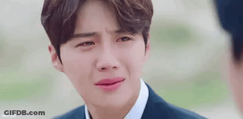 A Close Up Of A Man In A Suit And Tie Crying With His Eyes Closed . GIF