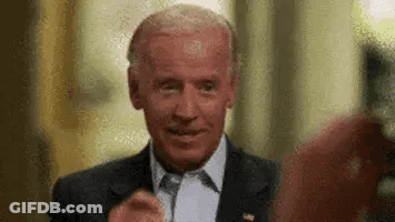 A Close Up Of A Man In A Suit And Tie Giving A Thumbs Up . GIF