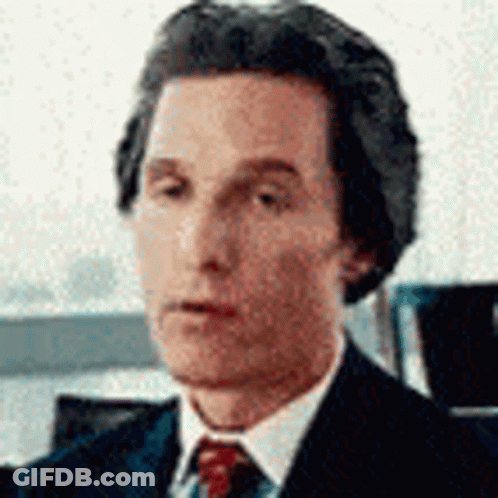 A Close Up Of A Man In A Suit And Tie Looking At The Camera . GIF
