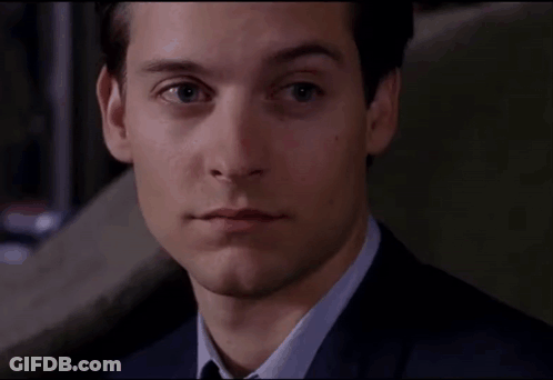 A Close Up Of A Man In A Suit And Tie Looking At The Camera GIF