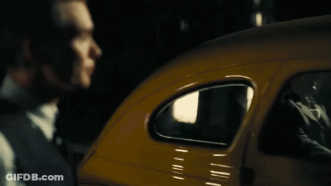 A Close Up Of A Man In A Suit And Tie Looking Down . GIF
