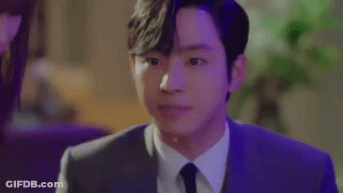A Close Up Of A Man In A Suit And Tie Making A Face . GIF