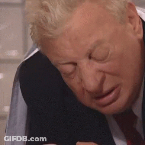 A Close Up Of A Man In A Suit And Tie Making A Face . GIF