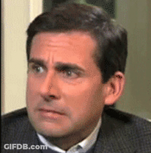 A Close Up Of A Man In A Suit And Tie Making A Funny Face . GIF