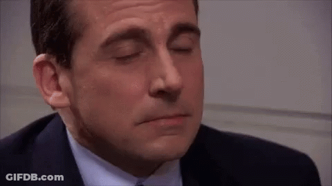 A Close Up Of A Man In A Suit And Tie Smiling GIF