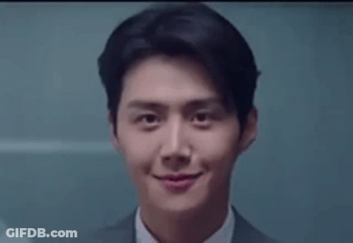 A Close Up Of A Man In A Suit And Tie Smiling At The Camera . GIF
