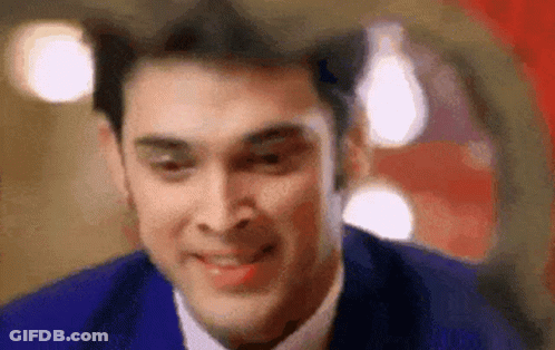 A Close Up Of A Man In A Suit And Tie Smiling . GIF