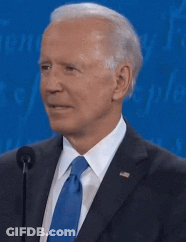 A Close Up Of A Man In A Suit And Tie Talking Into A Microphone . GIF