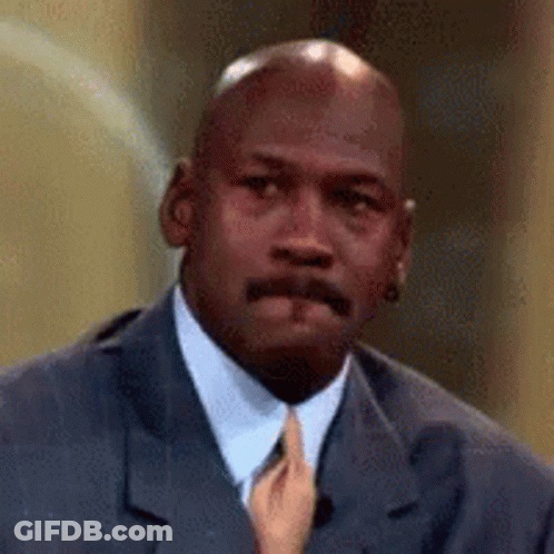 A Close Up Of A Man In A Suit And Tie With A Hand Holding His Tie . GIF