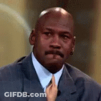 A Close Up Of A Man In A Suit And Tie With A Hand Holding His Tie . GIF