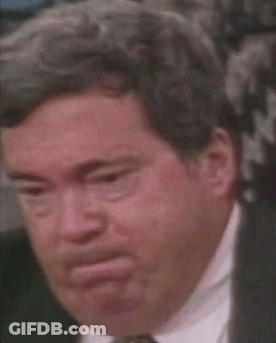 A Close Up Of A Man In A Suit And Tie With A Serious Look On His Face . GIF