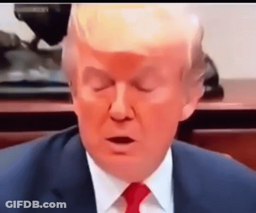 A Close Up Of A Man In A Suit And Tie With His Eyes Closed . GIF