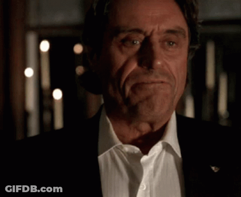 A Close Up Of A Man In A Suit And White Shirt With His Eyes Closed . GIF