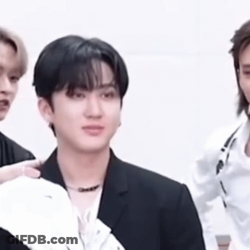 A Close Up Of A Man In A Suit Standing Next To Another Man . GIF