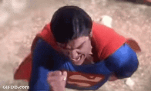 A Close Up Of A Man In A Superman Costume Flying Through The Air . GIF