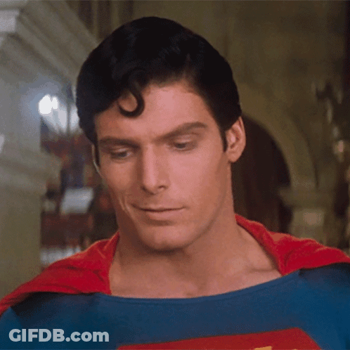 A Close Up Of A Man In A Superman Costume Looking Down GIF