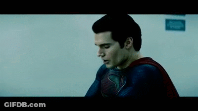 A Close Up Of A Man In A Superman Costume Looking Down . GIF