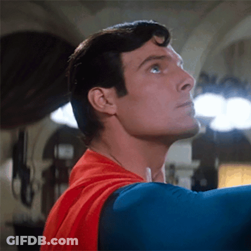 A Close Up Of A Man In A Superman Costume Looking Up GIF